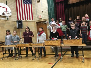 3rd graders perform with singing and musical instruments